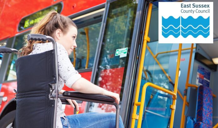 Person in a wheelchair boards a bus