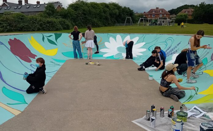 Young people giving Jarvis Brook skatepark a fresh lick of paint