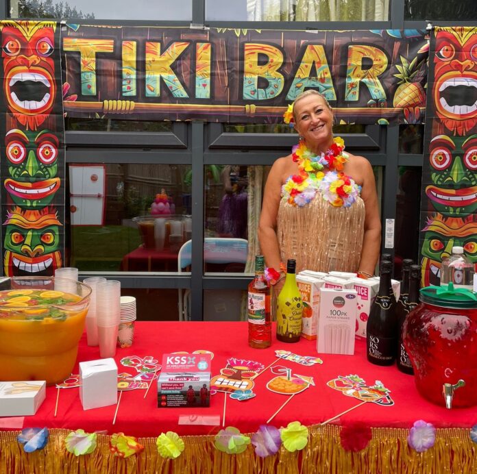 Woman in Hawaian fancy dress at care home's tropical fete